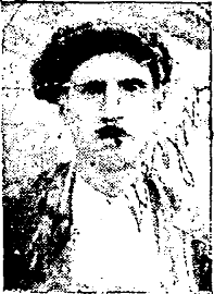 Grainy picture of a young man with a short moustache and a working-class Greek outfit, including a flat cap