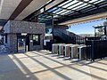 The Myki readers, Myki machine, stairs and fence at the concourse, December 2021