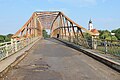 Bridge over the Bosut river with the Serbian Orthodox church in the background