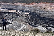 Photo of a person looking at a large open area in which coal mining has taken place