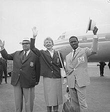 Three suited people in front of an airplane