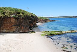 One of Eday's beaches, with sea caves adjacent to the southern end of Calf Sound