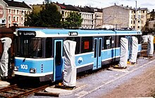 A light-blue tram