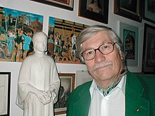 A color photograph of Hans Werner Sokop next to the statue of Dante from Giovnni Dupré