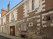 Photographie en couleurs de la façade d'un immeuble et pierre de taille et brique.