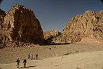 A group of hikers in a narrowing wadi in Egypt.