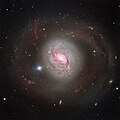 Messier 77 image showcasing its glittering arms criss-crossed with dust lanes.[10]