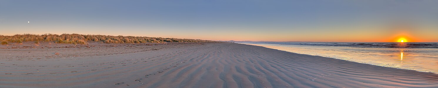 The sun and the moon in South New Brighton's beach, New Zealand