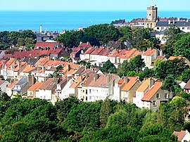 A general view from the Brecquerecque Quarter: The modern lighthouse, the medieval bell tower and the English Channel