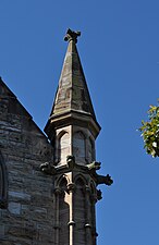 St Thomas Anglican church showing detail of spire to right of entrance.