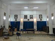 Large room with tables, chairs and a TV