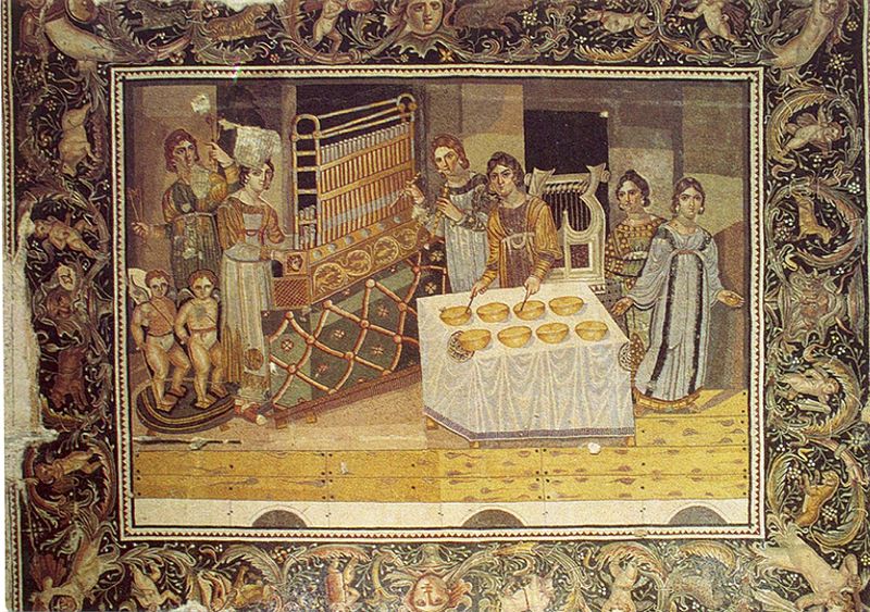 A cropped image of a photograph of a mosaic, which depicts two women playing a church organ like instrument