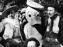 Man dressed as a gaucho with someone dressed as Donald Duck