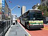 A bus stop with bus in the median of an urban arterial