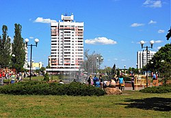 In the centre of town, with 16-floor one (left) and house with a clock (right) in sight.