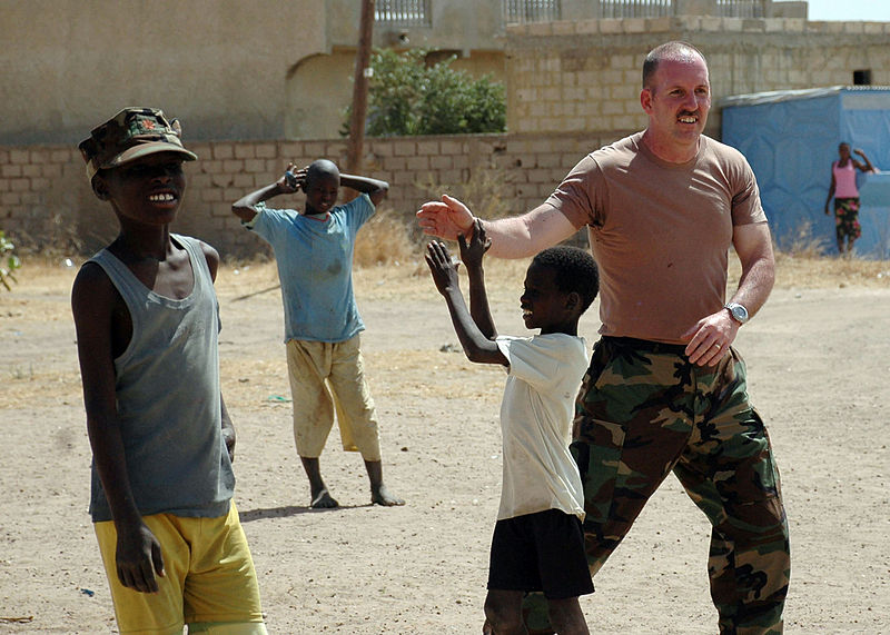 File:US Navy 090207-N-1655H-287 A service member from the U.S. Embassy in Dakar, Senegal, gives a high-five to a Senegalese boy while playing soccer at the Vivre Ensemble orphanage after a team of Africa Partnership Station 2009 mem.jpg