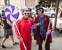 People dressed as Willy Wonka and as an Oompa-Loompa