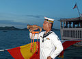 Royal Thai Navy bugler aboard HTMS Phutthayotfa Chulalok sounds a call marking evening colors