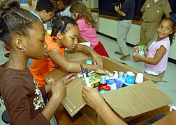 US Navy 070516-N-7653W-056 Students help each other carefully place items, such as toothpaste, mouthwash and other things the children collected into a box at the Betty Williams School in Norfolk.jpg