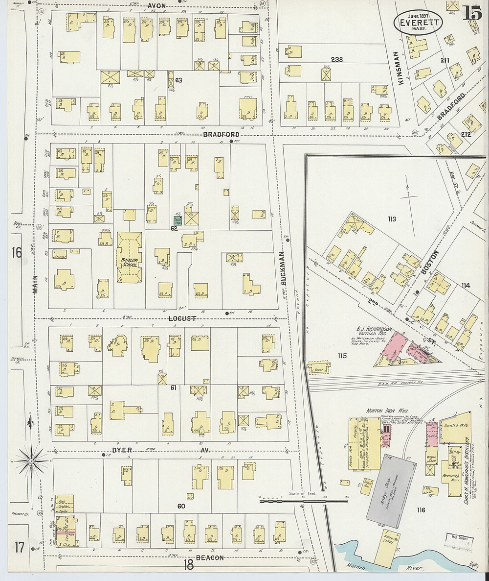 A section of an old property map, showing a small railroad station next to a three-track rail line