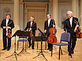 Image 9A modern string quartet. In the 2000s, string quartets from the Classical era are the core of the chamber music literature. From left to right: violin 1, violin 2, cello, viola (from Classical period (music))