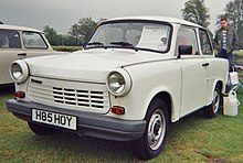 Two-door sedan with a man standing behind it