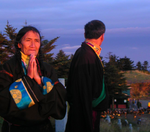 Woman watching the sunrise from summit of Mount Emei, China