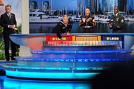 US Navy 070325-N-9195K-022 Machinist's Mate 2nd Class John Gates spins the wheel as a contestant on the popular television game show Wheel of Fortune.jpg