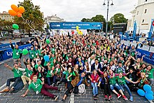 A large group of young people in green T-shirts