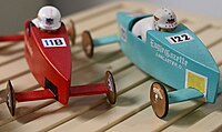 A closeup of two miniature Soap Box Derby models created by Derby historian and author Ron Reed