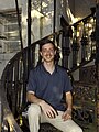 Timothy Holdiness posing on a cast iron spiral staircase.