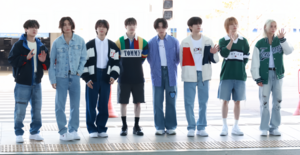 The eight members of Stray Kids, look forward