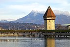 Wasserturm and Kapellbrücke, iconic symbols of the city of Lucerne, Switzerland. Mount Rigi can be seen in the background.