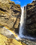 Kvernufoss waterfall with rainbow