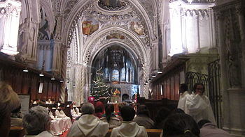 Photographie couleur d'un office liturgique dans une église de style troubadour.