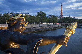 The Eiffel Tower with the church spire on the right from the Pont Alexandre III