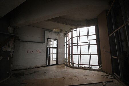 Exposed room with graffiti reading "FIX ME"