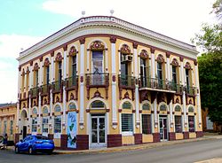 Photograph of a two-story building on an urban street corner