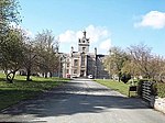 North Wales Hospital: Primary Range, including adjoining walled 'Airing Courts' to NW and SE