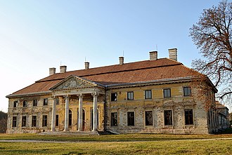 A large building with four columns at the entrance