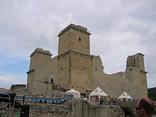 A fortress with four towers, surrounded with a moat