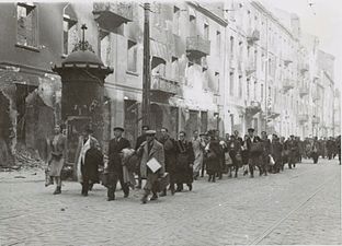 NARA copy #6, IPN copy #6 March to the rail station Column heading North to Umschlagplatz on Zamenhofa Street near Kupiecka. In the back buildings of Zamenhofa 30-40 block.