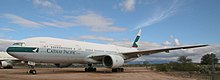 View of twinjet aircraft parked on desert area.