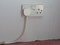 UK BS1363 domestic mains double wall socket, one with a BS1363 plug in