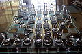 A translucent chess set arranged for visual effect. It is unlikely that a real chess match would unfold into such a perfectly symmetrical configuration.