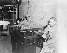 Two men sitting at a desk.