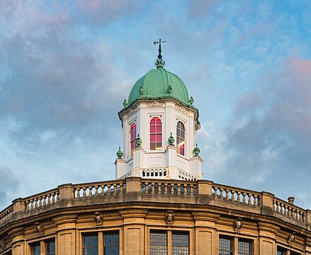 Sheldonian Theatre roof cupola in Oxford seen from Broad Street, in evening light.