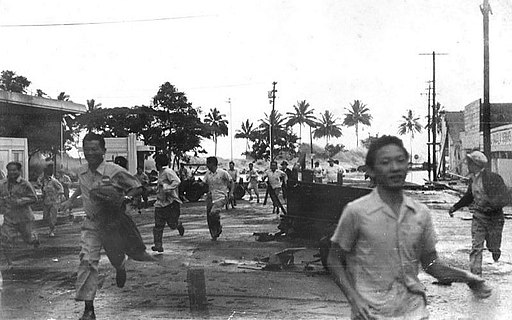 People run from an approaching tsunami in Hilo, Hawai'i, on 1 April 1946; note the wave just left of the man's head in right center of image.