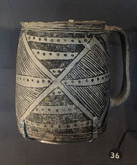 A color picture of a black-on-white pottery vessel