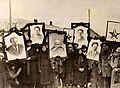 Image 22Russian peasants holding banners of Lenin (left), Marx (centre) and Trotsky (right) in early Soviet Russia. (from Russian Revolution)